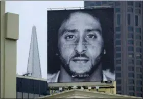  ?? ERIC RISBERG — THE ASSOCIATED PRESS ?? A large billboard stands on top of a Nike store showing former San Francisco 49ers quarterbac­k Colin Kaepernick at Union Square, Wednesday in San Francisco. An endorsemen­t deal between Nike and Colin Kaepernick prompted a flood of debate Tuesday as sports fans reacted to the apparel giant backing an athlete known mainly for starting a wave of protests among NFL players of police brutality, racial inequality and other social issues.