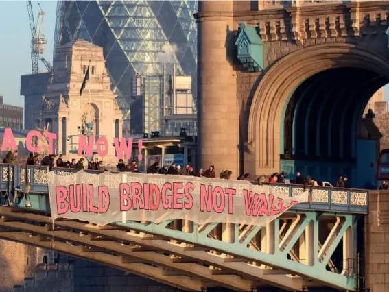  ??  ?? A banner unfurled on Tower Bridge in London as part of the Bridges Not Walls protest against President Donald Trump’s inaugurati­on (PA)