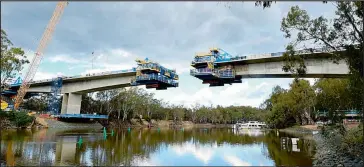  ??  ?? The new Echuca-Moama bridge over the Murray River is getting closer to meeting in the middle.