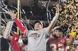  ?? David J. Phillip AP ?? KANSAS CITY Chiefs’ Patrick Mahomes, center, and Tyrann Mathieu, right,celebrate after defeating the San Francisco 49ers in Super Bowl LIV on Sunday.