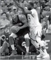  ?? ASSOCIATED PRESS ?? HOUSTON ROCKETS FORWARD P.J. Tucker (left) is pressured by Golden State Warriors forward Draymond Green (23) during the first half in Game 2 of the NBA basketball Western Conference Finals Wednesday in Houston.