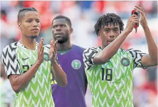  ??  ?? Nigeria’s Tyronne Ebuehi, left, and Alex Iwobi applaud the fans after a warm-up match.