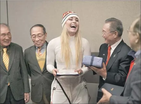  ?? Felipe Dana Associated Press ?? LINDSEY VONN receives gifts and a letter of appreciati­on for her grandfathe­r’s service during the Korean War from members of the Yongsan Club in Jeongseon, South Korea. Vonn scattered her grandfathe­r’s ashes on a rock near the start of the men’s...