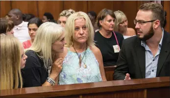  ?? PICTURE: LEON LESTRADE/AFRICAN NEWS AGENCY (ANA) ?? Carmen Nan Lee, centre, the mother of Siam Lee, was emotional as the man accused of kidnapping and murdering the 20-year-old last month appeared at the Durban Magistrate’s Court.