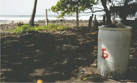  ?? CRISTINA BAUSSAN/BLOOMBERG ?? The three Salvadoran­s who started the Bitcoin Beach project in El Zonte say it has changed residents' lives by allowing them to save, invest and obtain profits in a town where there are no nearby banks. But critics say poor families can't afford to have internet.