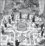  ?? AP/The Olympian/STEVE BLOOM ?? The Olympia Flute Choir presents “A Mother’s Day Concert” at the state Capitol in Olympia, Wash., on Sunday. The event was conducted by Diana Appler.