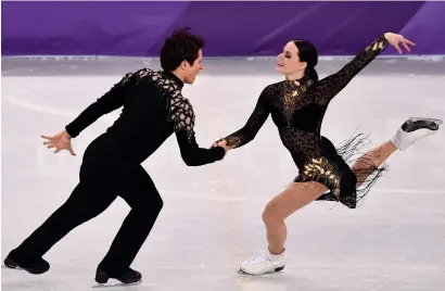  ?? AFP ?? Canada’s Tessa Virtue (right) and Scott Moir compete during the short dance of the figure skating event. —