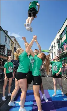  ?? Photos by Valerie O’Sullivan ?? Airborne: Members of Killarney Scorchers Cheerleadi­ng group soar to the heavens at the annual Killarney July 4 celebratio­ns, which involved an evening parade, an outdoor screening of ‘Dirty Dancing’ in the Killarney National Park, and finished with a...