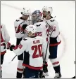  ?? MICHAEL DWYER – THE ASSOCIATED PRESS ?? Washington Capitals goalie Darcy Kuemper celebrates with teammates after defeating the NHL-best Boston Bruins.