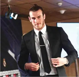  ??  ?? MADRID: Real Madrid’s Welsh forward Gareth Bale leaves a press conference in the media room at the Santiago Bernabeu stadium in Madrid yesterday. Real Madrid and Gareth Bale have agreed an extension to the player’s contract, keeping him at the club...