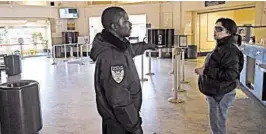  ?? BEN MARGOT/AP ?? Security guard Damoi Shilon speaks with a customer Tuesday at the Greyhound bus terminal in Oakland. A bus shooting Monday left one person dead and five wounded.