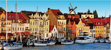  ?? ?? Delightful Denmark: Colourful buildings of Sønderborg’s port. Right, cycling friends