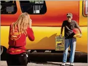  ?? CASSIDY ARAIZA/THE NEW YORK TIMES ?? Rock Kramer, a collector of Wienermobi­le merchandis­e for 25 years, poses with the Oscar Mayer Wienermobi­le in El Paso, Texas. Even as demand for Kraft Heinz comfort foods grew in 2020, the pandemic put a halt to the famous traveling show.