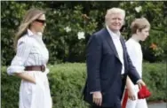  ?? THE ASSOCIATED PRESS ?? President Donald Trump, first lady Melania Trump, and their son and Barron Trump, walk to Marine One across the South Lawn of the White House in Washington on Saturday en route to Camp David in Maryland.