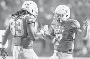  ?? Tom Reel / San Antonio Express-News ?? With Shane Buechele, right, smoothly handling his first college game and Tyrone Swoopes making timely contributi­ons, Texas appears to have solved the quarterbac­k problems that have plagued it recently and is primed for a bounce-back season after...