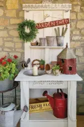  ??  ?? Above: A potting bench made from a salvaged door was purchased from a friend and now extends a warm welcome on Sonna and Bruce’s back porch. Garden goods, including an old birdhouse and several vintage watering cans, complement the piece. “My mom was crazy about old watering cans,” Sonna notes.