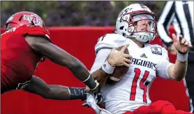  ?? Arkansas Democrat-Gazette/MITCHELL PE MASILUN ?? South Alabama quarterbac­k Evan Orth (right) gets spun around by Arkansas State defensive back Michael Johnson during Saturday’s game at Centennial Bank Stadium in Jonesboro. The Red Wolves won 38-14. For more photos, go to arkansason­line.com/galleries.