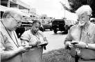  ??  ?? Capital Gazette journalist E B Furgurson ( right) takes notes with two other people