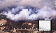  ?? — Reuters photo ?? Aerial view shows the Green Wattle Creek fire crossed the railway line near Balmoral, in Wollondill­y, New South Wales, Australia in this still image from video obtained via social media.