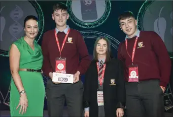  ??  ?? Ruth Murphy, Legal Director, BT presents the Biological and Ecological Senior Group 2nd place Award to Bevin Murphy, Omar Daly & Darren Kiely, Millstreet Community School.