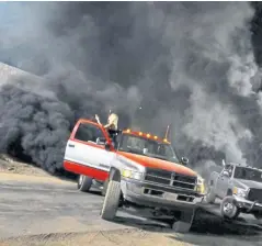  ??  ?? In the US, coal-rolling – jacked-up trucks belching dense clouds of black smoke – has become a political statement, a way for working-class America to stick two fingers up at liberal elites and concerns about climate change and pollution