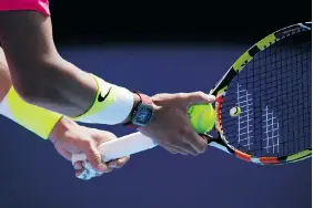  ?? BERNAT ARMANGUE/The Associated Press ?? Sensors embedded in the handle of Spaniard Rafael Nadal’s racket, made by Babolat,
record technical data on every ball struck.