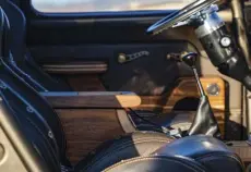  ??  ?? The same walnut and maple used on the bed floor was used for the custom center console and door panels.