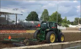  ?? KEVIN MARTIN —THE MORNING JOURNAL ?? A tractor prepares the grounds in preparatio­n for the truck pull on Aug. 23 at the Lorain County Fair in Wellington.