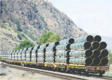  ?? GERRY KAHRMANN / POSTMEDIA FILES ?? Pipes destined for the Trans Mountain pipeline are transporte­d by rail through Kamloops this past June.