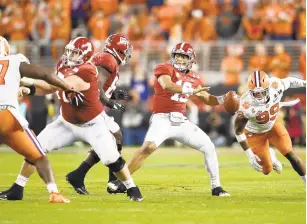  ?? EZRA SHAW/GETTY IMAGES ?? Alabama’s Tua Tagovailoa looks to pass under pressure from Clemson’s Clelin Ferrell during last Monday’s national championsh­ip game. Clemson dominated an undefeated then-No. 1 Alabama to win the title.