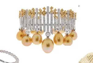  ??  ?? Bangle in 18K gold with golden South Sea pearls and fancy yellow diamonds, BELFORDEmb­race bangle in 18K yellow gold with baby Akoya pearls and diamonds, QAYTEN