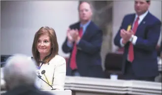  ?? Mickey Welsh / Associated Press ?? Rep. Terri Collins, R-Ala., gets a standing ovation after her near total ban on abortion bill passes the House at the Alabama Statehouse in Montgomery, Ala., on Tuesday.