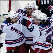  ?? AP PHOTO BY SETH WENIG ?? New York Rangers’ Mika Zibanejad, rights celebrates his goal with teammates during the third period of the NHL hockey game against the New Jersey Devils in Newark, N.J., Sunday, April 18.