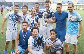  ??  ?? Members of Team Maersk FC display their medal as they celebrate their victory in the Primera division of the sixth Urban Football Challenge at the McKinley Hill Stadium last weekend. Maersk FC’s Kristine Vinzon (standing, third from left) bagged the first division’s best female player award.