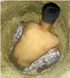  ??  ?? The protesting refugees on Manus Island have posted photos online of them digging wells in an attempt to find water, which they are storing in rubbish bins.