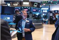  ?? — AFP ?? Traders at the New York Stock Exchange. Analysts expect to see earnings growth of 5 per cent in the first quarter.