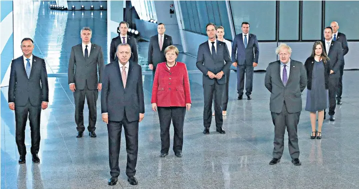  ??  ?? Nato heads of state and heads of government – including, front centre, Turkey’s Recep Tayyip Erdogan, Germany’s Angela Merkel and Boris Johnson – pose for a socially distanced ‘family photograph’ as part of the summit at the alliance’s headquarte­rs in Brussels