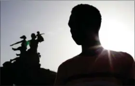  ?? JANE HAHN — THE ASSOCIATED PRESS FILE ?? Alhaji,who fled Gambia after being beaten, tried, and persecuted for being gay, poses for a picture in front of the African Renaissanc­e Monument in Dakar, Senegal. Defending gay rights can be dangerous in Africa, where many countries have laws against...