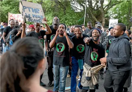  ??  ?? Supporters of President Jacob Zuma confront demonstrat­ors calling for Zuma’s removal outside the home of the controvers­ial Gupta family in Johannesbu­rg, South Africa.