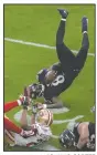  ?? AP/JULIO CORTEZ ?? Baltimore Ravens quarterbac­k Lamar Jackson (8) flips after being tripped Sunday by San Francisco 49ers cornerback Ahkello Witherspoo­n (23) in the first half.