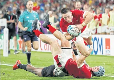  ?? REUTERS ?? Wales’ Josh Adams scores his team’s third try against Fiji during their Pool D match in Oita yesterday.