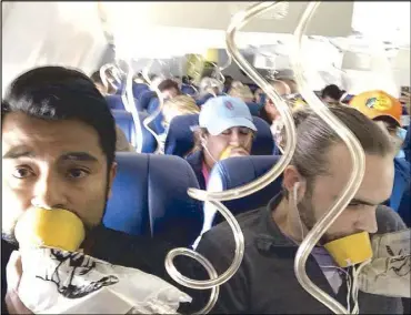 ?? AP ?? Marty Martinez (left) appears with other passengers after a jet engine blew out on the Southwest Airlines Boeing 737 plane he was flying in from New York to Dallas. Martinez livestream­ed the descent on Facebook.