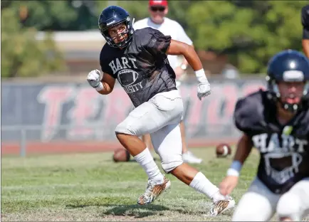  ?? Katharine Lotze/The Signal (See additional photos on signalscv.com) ?? Hart High senior Julian Salazar runs a warm-up drill at Indians practice Monday at Hart. Salazar is taking over at middle linebacker this year after Hart graduated All-Foothill League backer Charles Ike in the spring.