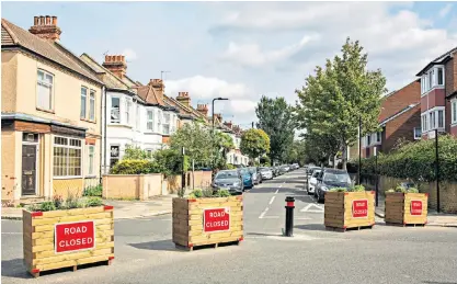  ?? ?? Dead end: planter boxes block cars and vans from driving through LTN (low-traffic neighbourh­ood) streets in Ealing, west London