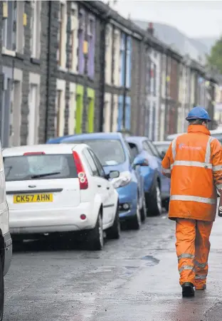  ??  ?? Workmen help with the clean-up after the flash floods in Pentre