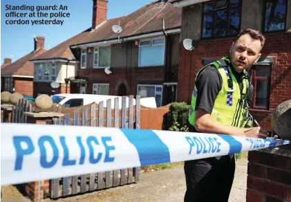  ??  ?? Standing guard: An officer at the police cordon yesterday