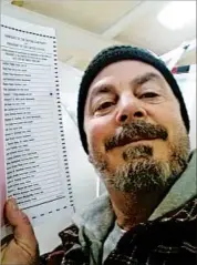  ?? BILL PHILLIPS/AP ?? Bill Phillips of Nashua, N.H., poses with his marked election ballot from the state’s GOP primary in February.