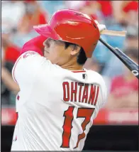  ?? The Associated Press ?? Mark J. Terrill
Shohei Ohtani breaks his bat as he hits an RBI single during the first inning of the Angels’ 6-2 victory over the Rockies at Angel Stadium.