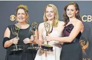  ?? [AP PHOTO] ?? Ann Dowd, from left, winner of outstandin­g supporting actress in a drama series; Elisabeth Moss, winner of outstandin­g lead actress in a drama series; and Alexis Bledel, winner of outstandin­g guest actress in a drama for “The Handmaid’s Tale,” pose in...