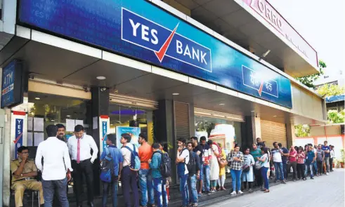  ??  ?? AT A YES BANK branch in Mumbai, depositors waiting to withdraw money.